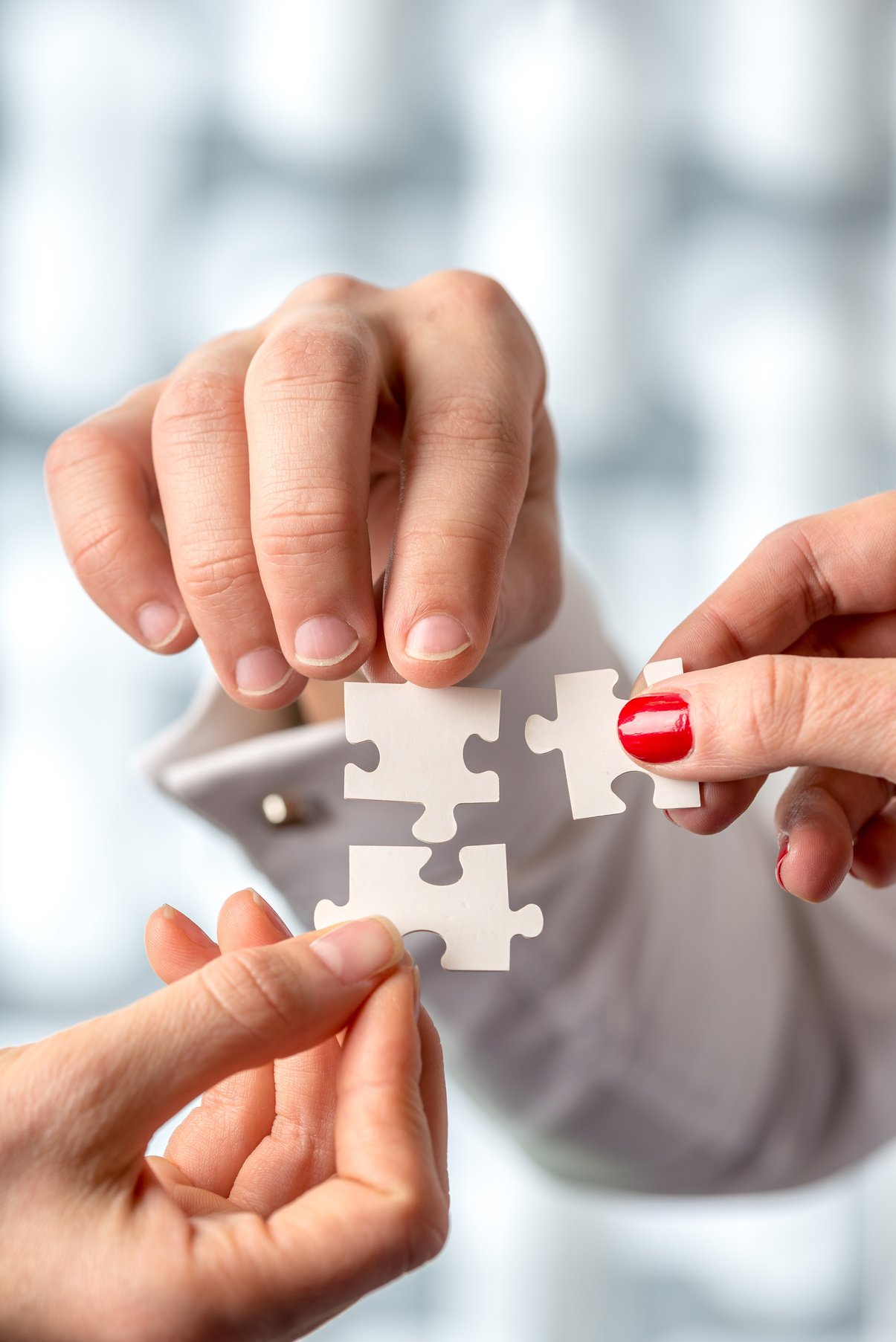 Conceptual Human Hand Holding Puzzle Pieces